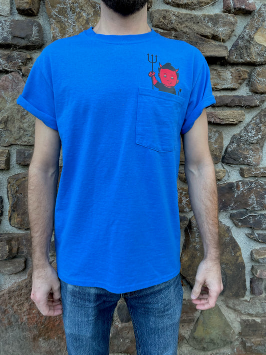 Bring your favorite baby devil, Bartleby, with you where ever you go, tucked in your t-shirt pocket right next to your heart. This blue T-shirt with the devil in the pocket is fun, quirky, and cute, with "Bartleby's" written on the back between the shoulders, allowing you to rep your favorite small woman-owned business. T-shirts ship free!